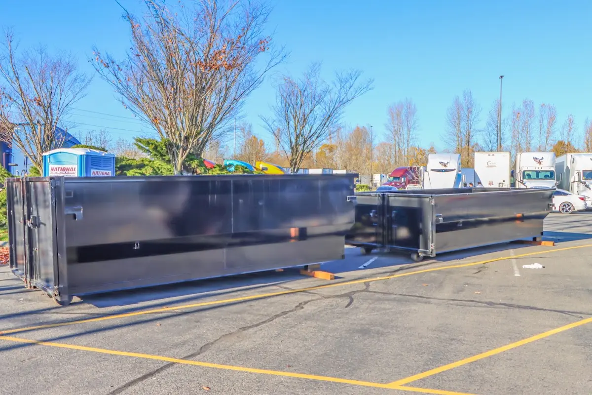Professional dumpster rental service with roll-off container on residential driveway in Riverdale Park